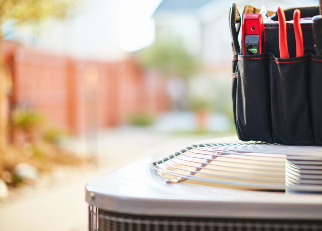 Air conditioner with maintenance tools in residential back yard